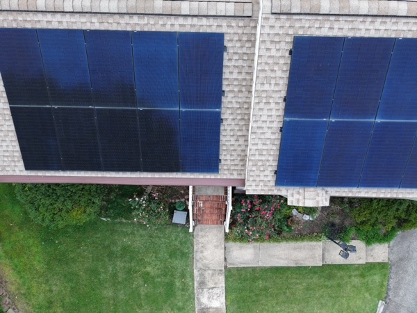 Close-up aerial view of two rows of rooftop solar panels